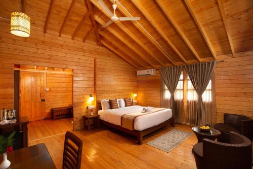 a bedroom with a bed in a wooden room at The Porcupine Castle Resort in Madikeri