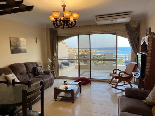a living room with a view of the ocean at LA VISTA Ain Elsokhna 1&2 Chalet in Ain Sokhna