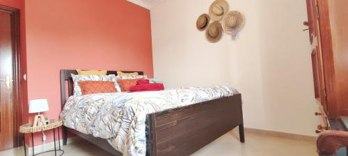 a bedroom with a bed with colorful pillows on it at casa de vicky in El Puerto de Santa María