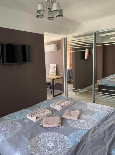 a bedroom with a bed with two towels on it at Luxury apartment in Chişinău