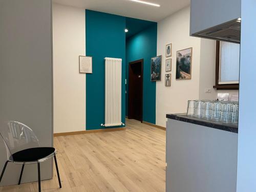 a room with a white radiator and a blue wall at House of Bruno - Only self check-in in Trento