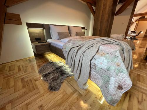 a dog standing in a bedroom with a bed at La Luna Rustic Deluxe Apartment with Free Jacuzzi, Bikes & Covered Parking in Našice
