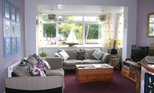 a living room with a couch and a coffee table at The Swiss Cottage, Shanklin in Shanklin