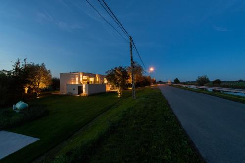 a house on the side of a road at night at Yzerdyck in Diksmuide