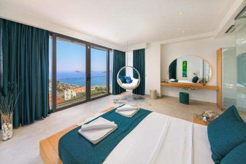 a bedroom with a large bed and a large window at Villa Pax - Kalkan Villa in Kas