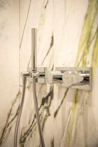 a shower head on a wall in a bathroom at Yzerdyck in Diksmuide