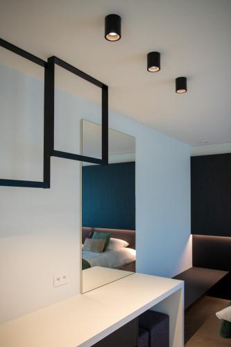 a room with a bed and a mirror on the wall at Yzerdyck in Diksmuide