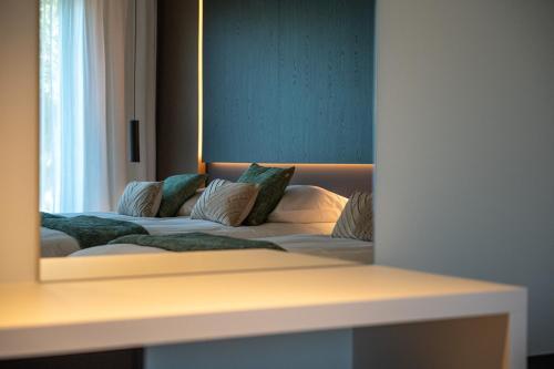 a bedroom with a bed with a large mirror at Yzerdyck in Diksmuide