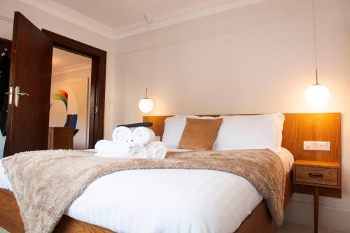 a bedroom with a large bed with towels on it at The Old Mount Manor - Causeway Coast in Coleraine