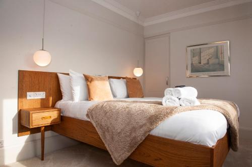 a bedroom with a large bed with towels on it at The Old Mount Manor - Causeway Coast in Coleraine