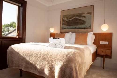 a bedroom with a bed with towels on it at The Old Mount Manor - Causeway Coast in Coleraine