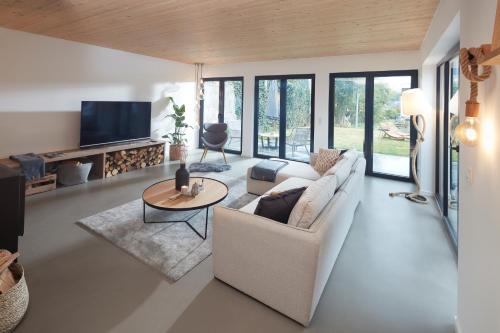 a living room with a couch and a table at Chalet 48 in Mayen