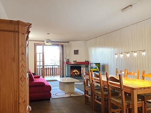 a dining room with a table and a fireplace at Les Mayens de l'Ours - At the foot of Piste de l'Ours' slope! in Agettes