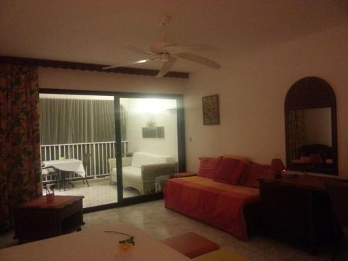 a bedroom with a bed and a living room at Just in paradise in Baie Nettle