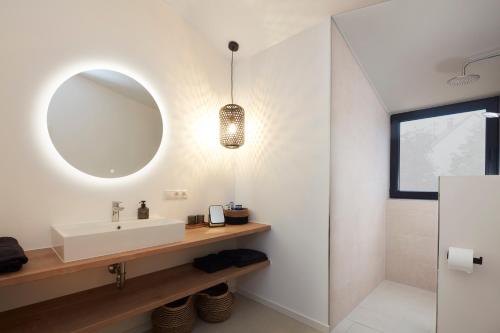 a bathroom with a sink and a mirror at Chalet 48 in Mayen