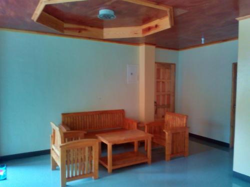 a room with a table and chairs and a ceiling at MOTHER MARRY INN in Sagada