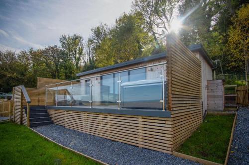 a house with a large window on the side of it at The Rhossili Bay Secret - 1 Bed Cabin - Landimore in Gowerton