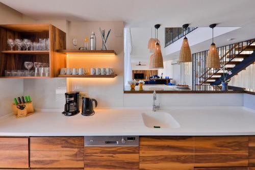 a kitchen with a sink and a staircase at Villa Lapis - Kalkan Villa in Kas