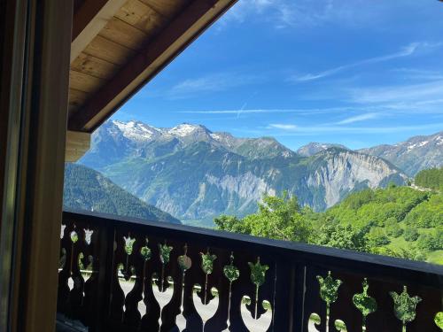 a balcony with a view of mountains at Chalet Fontaines in LʼHuez