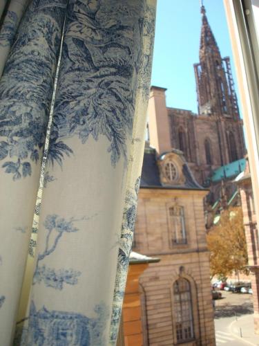 a blue and white curtain in front of a church at Hotel Suisse in Strasbourg