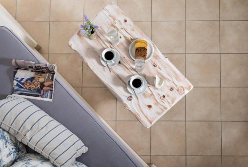 a table with two cups and drinks on it at Athermi Suites - Adults Only in Megalokhori