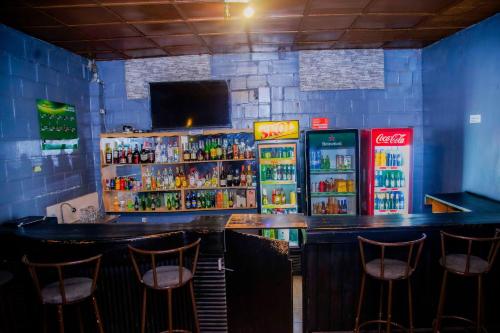 a bar with some drinks and soda machines at Room in BB - Martin Aviator Hotel in Kigali