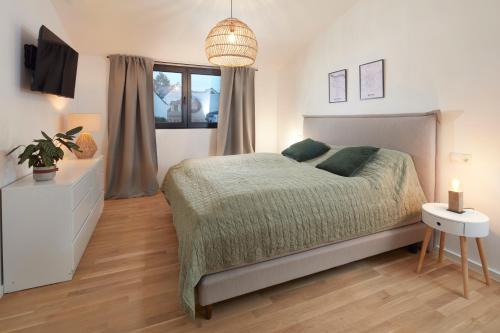 a bedroom with a large bed and a window at Chalet 48 in Mayen