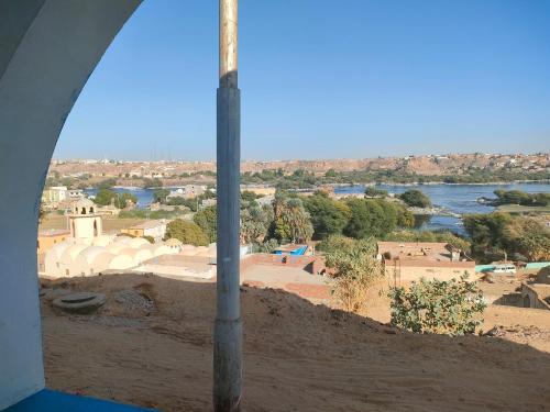a view of a city and a river from a window at Nukud guest house in Aswan