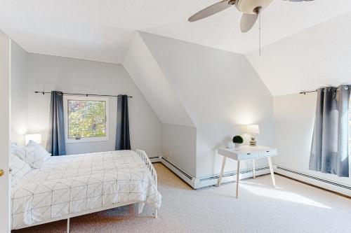 a white bedroom with a bed and a window at Kingswood Mountainside Retreat in White River Junction
