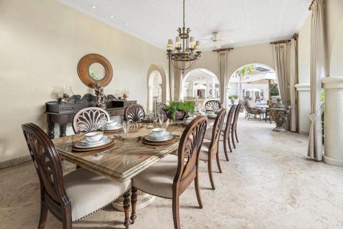 a dining room with a wooden table and chairs at Royal Westmoreland- Wild Cane Ridge 2 by Island Villas in Saint James