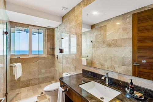 a bathroom with a sink and a toilet at Blue Horizon 802 in Puerto Vallarta