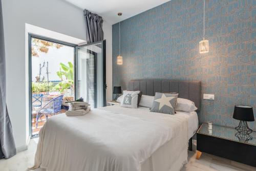 sypialnia z dużym łóżkiem i niebieską ścianą w obiekcie Dreams of Marbella Old Town w Marbelli
