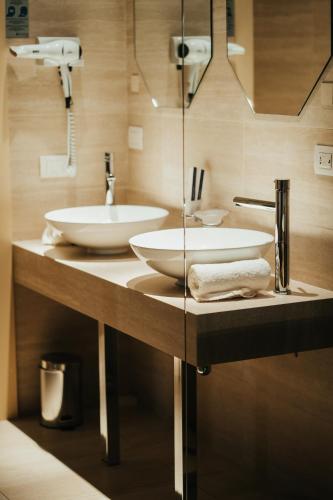 a bathroom with two sinks on a counter at Emotional Grand Motel in Fontaneto dʼAgogna
