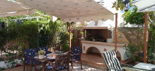 a patio with a table and a fireplace at Little heaven in Alimos/Athens! in Athens