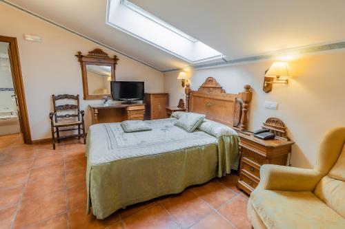 桑托多明戈德西洛斯的住宿－聖多明各-德錫洛斯酒店，一间卧室配有一张床、一张桌子和一把椅子