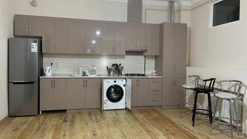 a kitchen with a washing machine and a dishwasher at Ashtarak Garden GuestHouse in Ashtarak