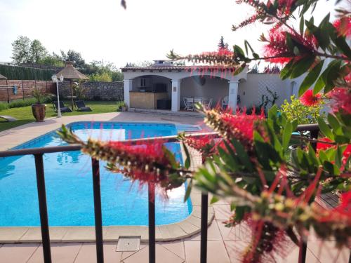 a swimming pool in front of a house at Les chambres d'hôtes d'Eloïse, piscine privée in Aramon