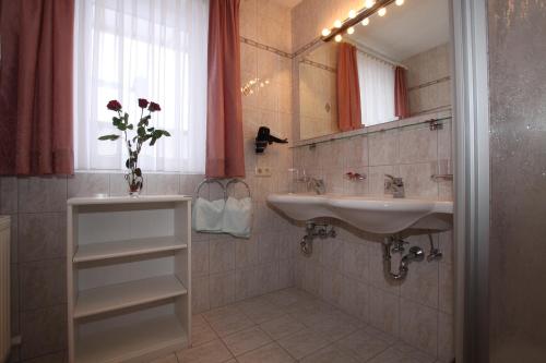 a bathroom with a sink and a mirror at Bella Vista Apartments in Nauders