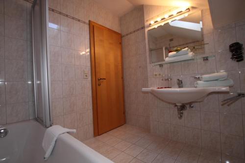 a bathroom with a tub and a sink and a bath tub at Bella Vista Apartments in Nauders