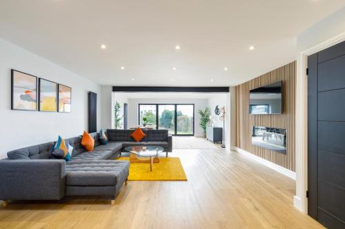 a living room with a couch and a table at Free Parking Stylish & modern 4-bedroom home with sea views in Brighton & Hove