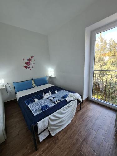 a bedroom with a bed and a large window at Curti Granda in Rescaldina