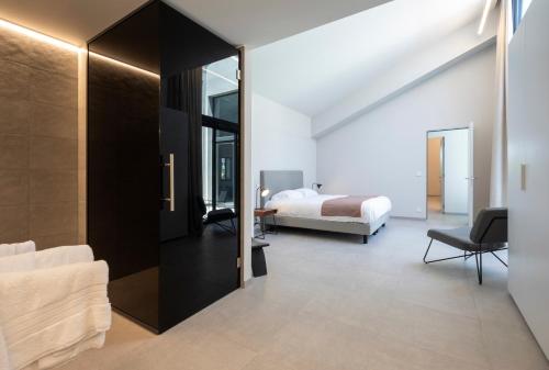 a bedroom with a bed and a room with a mirror at Les Orangers by Sezz in Saint-Tropez