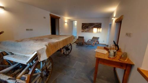 a room with a bed and a desk and a table at Corte Varola B&B Zia Marisa in Belluno