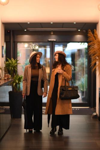two women walking down a hallway in a building at Best Western Hotel Hebron in Copenhagen