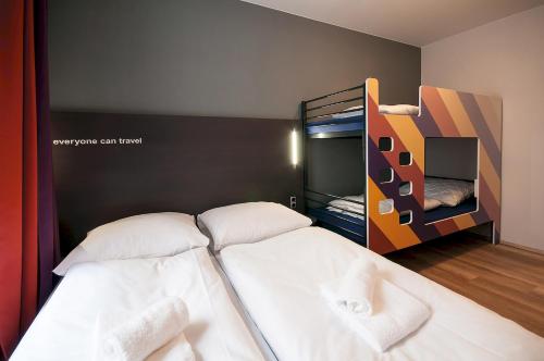 a bedroom with a bed and a television at a&o Edinburgh City in Edinburgh