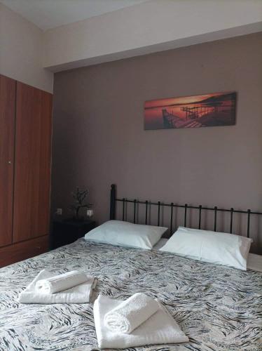 a bed with two white pillows on top of it at Eirini's Apartment in Missolonghi