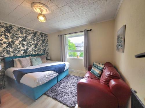 a bedroom with a bed and a couch and a window at Business & Familes Three Bedrooms By Sensational Stay Short Lets & Serviced Accommodation, Aberdeen With Balcony & Free Parking in Aberdeen