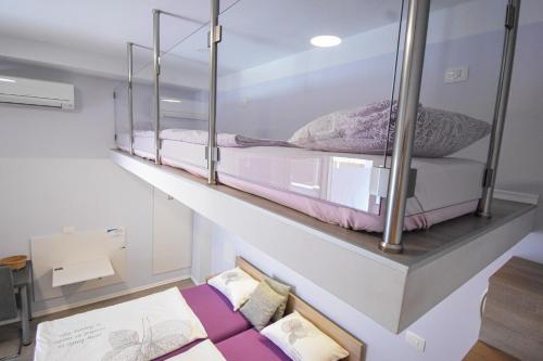 two bunk beds on a wall in a room at Apartmaji Sobe Zvezda in Pobegi