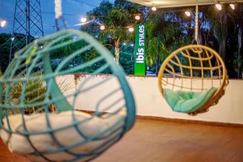 two swings on a ride at a theme park at ibis Styles Ribeirao Preto Maurilio Biagi in Ribeirão Preto