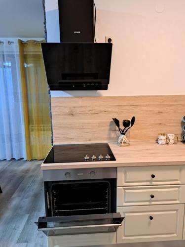 a kitchen with a stove and a counter top at Apartman Stefany in Varaždin